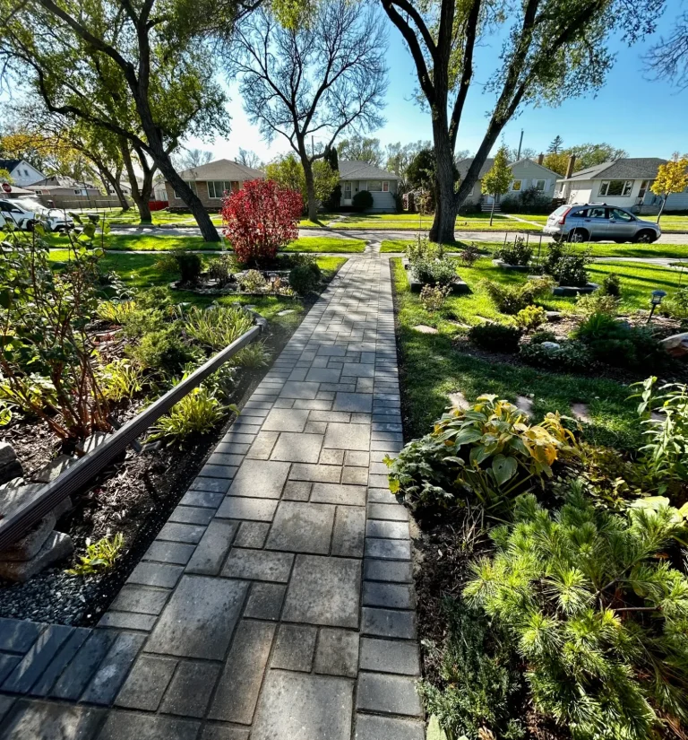 Barkman Verano paver front sidewalk with perennial gardens throughout completed by Genesis Interlocking & Custom Landscaping 