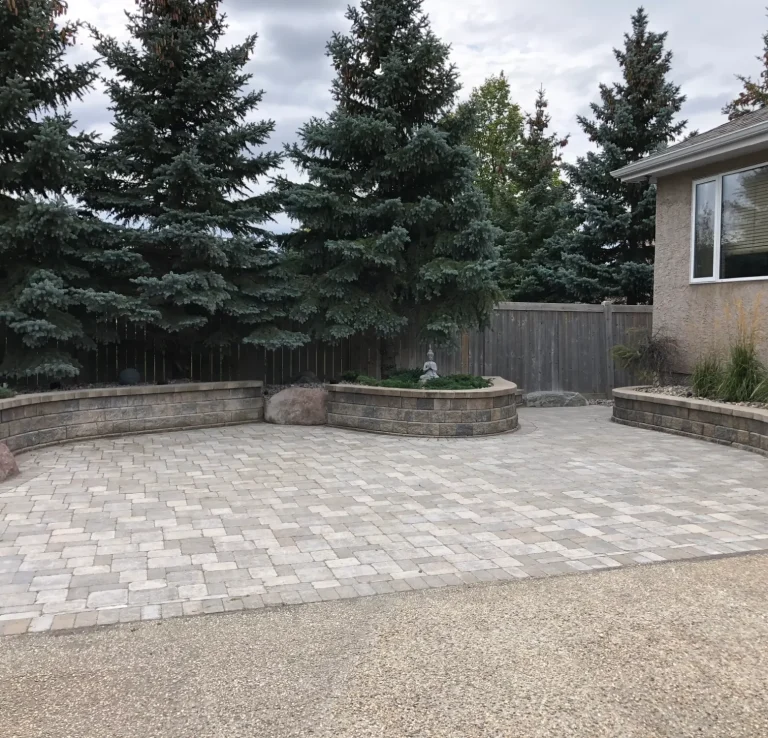 Barkman Concrete Roman Pavers Patio In Sierra Grey with Pisa2 Retaining Wall Flower Gardens